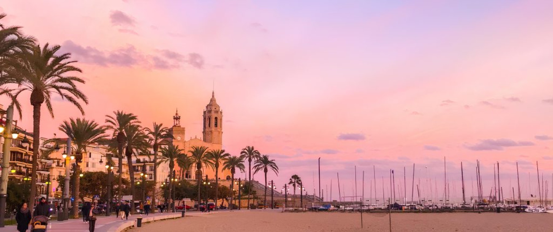 Sitges seafront at sunset, church and marina